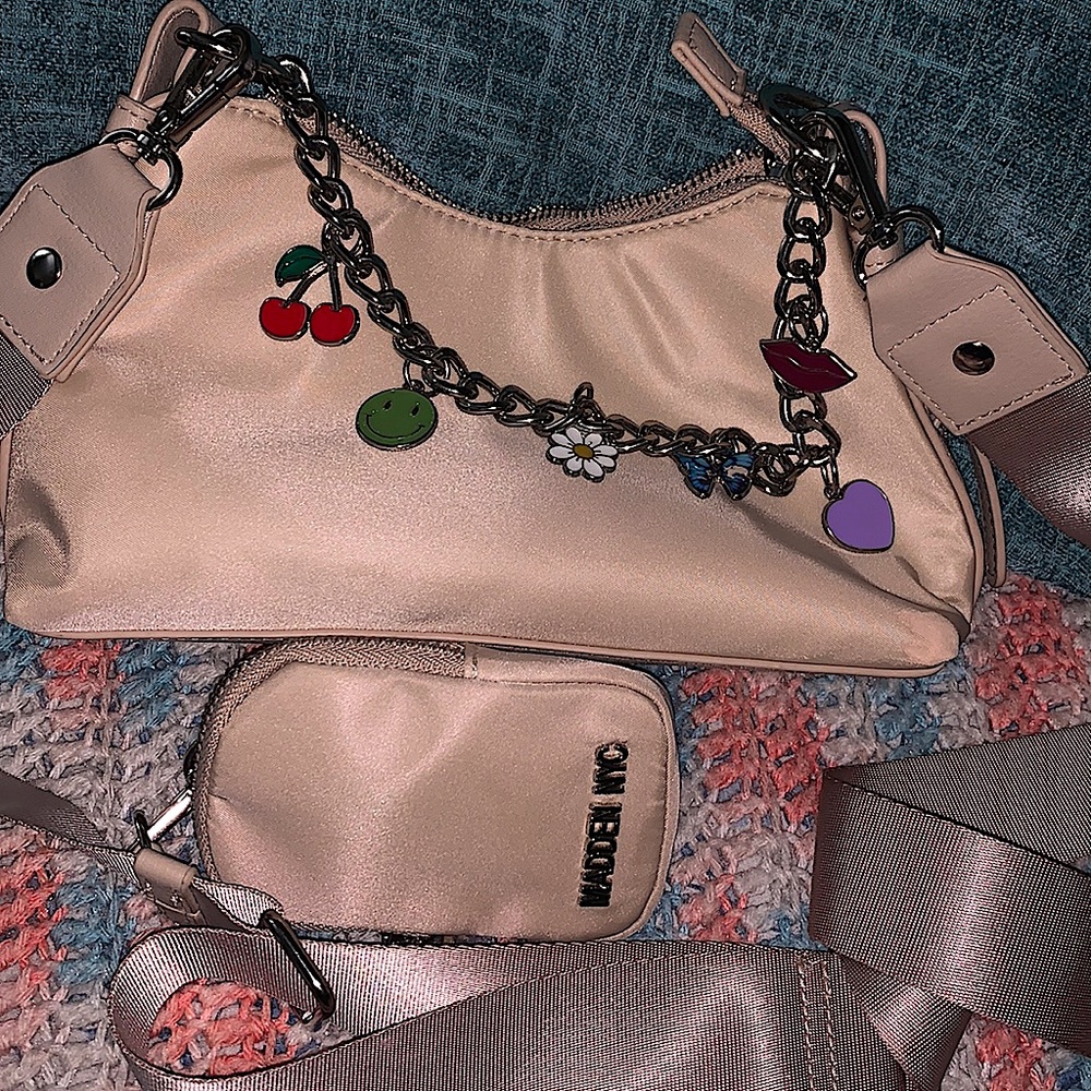A cream charmed purse with a little wallet purse connected